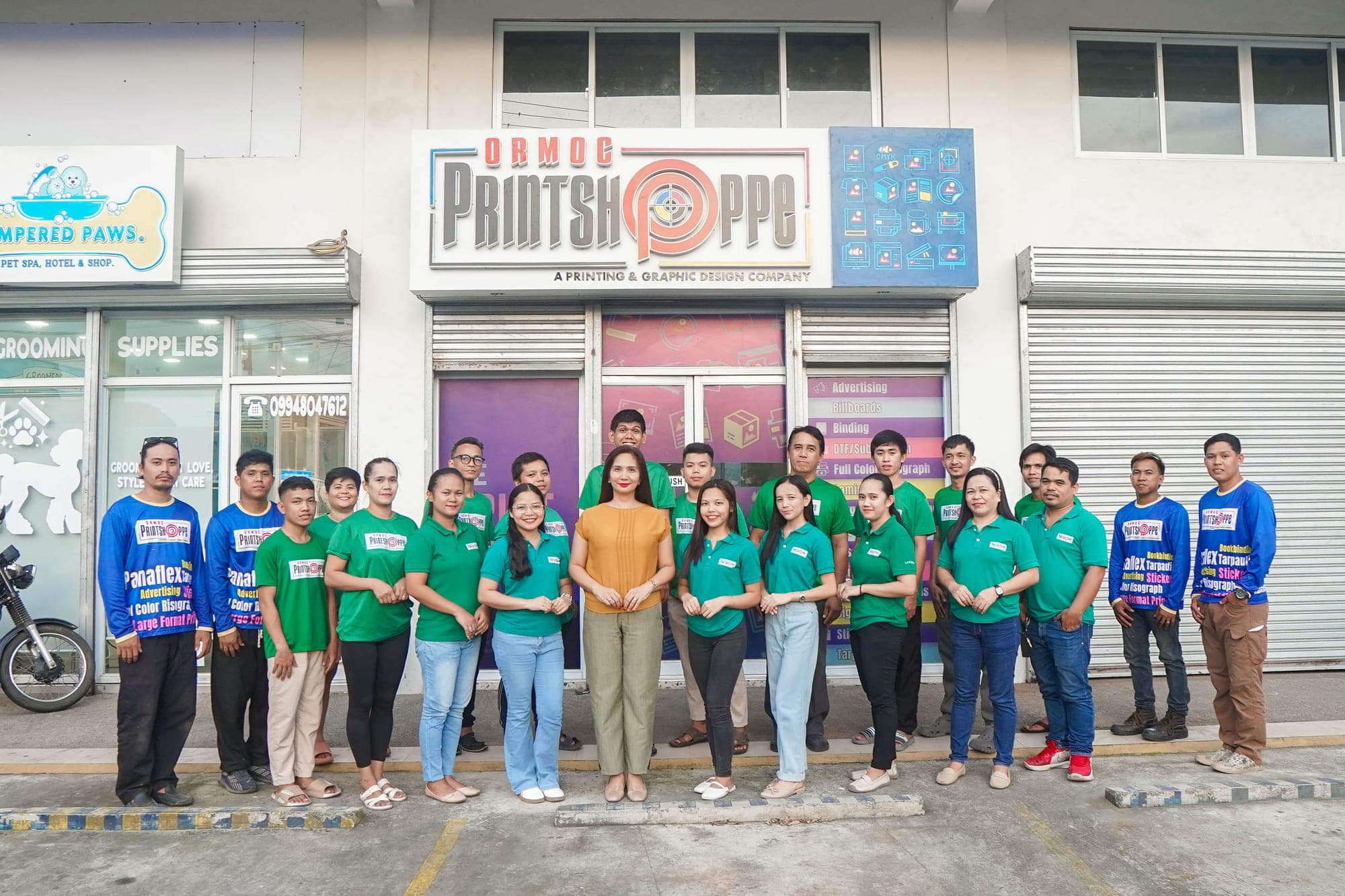 The Ormoc Printshoppe team outside the shop